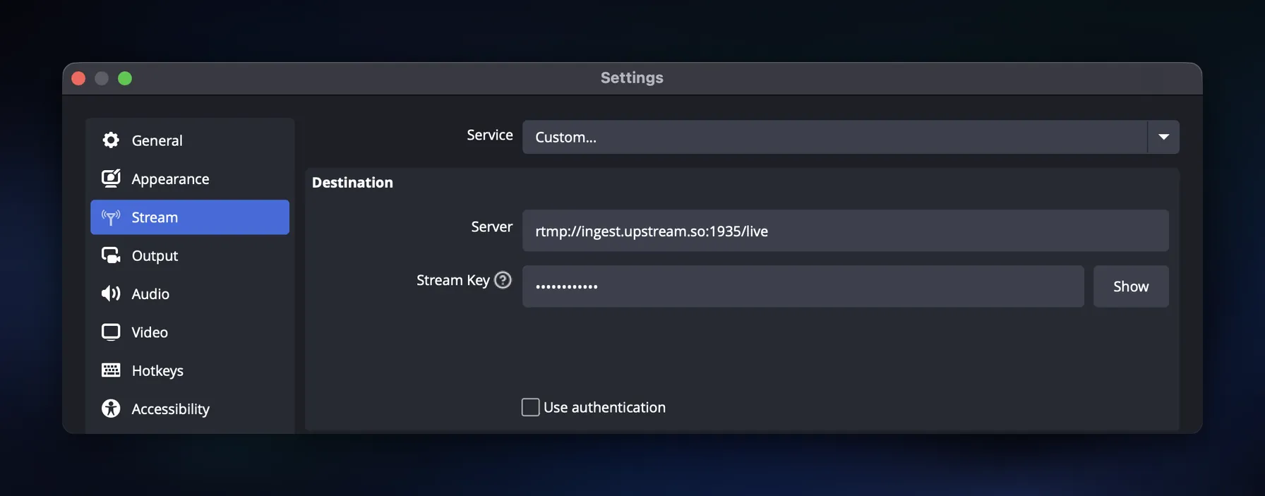 OBS Stream settings with Service set to Custom and the Server field showing the Upstream RTMP ingest URL, with the stream key masked.